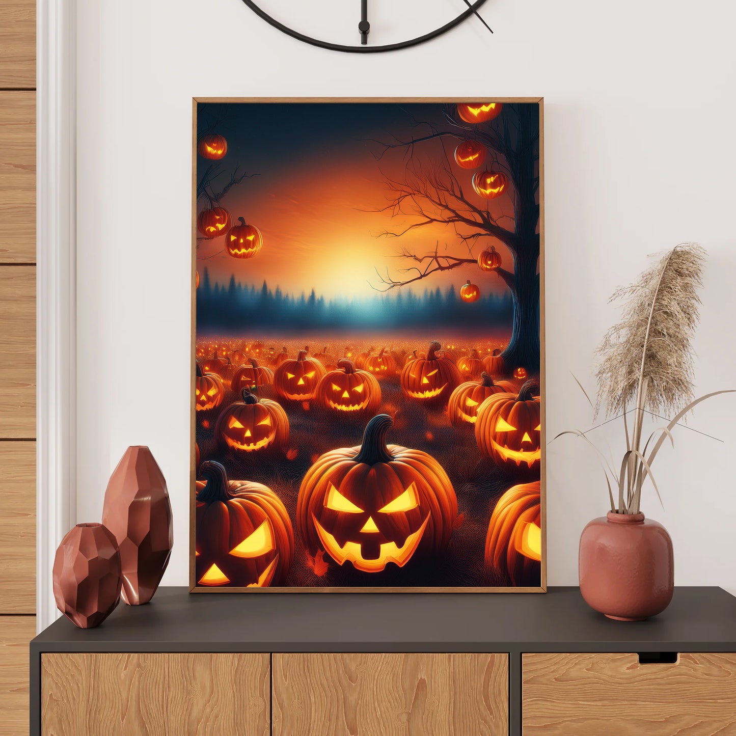Framed Halloween-themed artwork of jack-o'-lanterns on a wall above a console table.