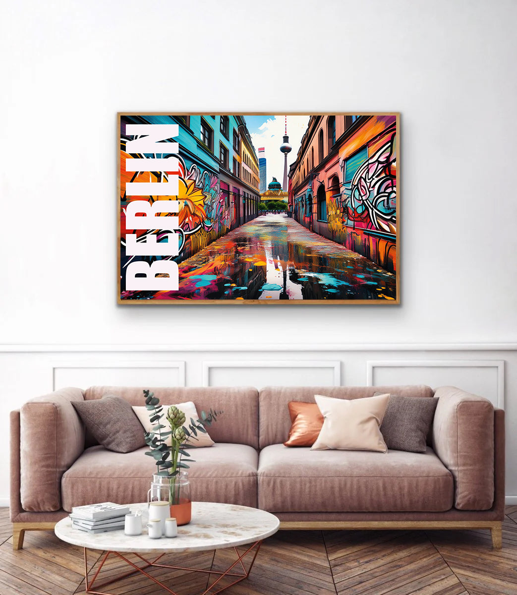 Colorful Berlin-themed artwork on a wall above a sofa in a living room.