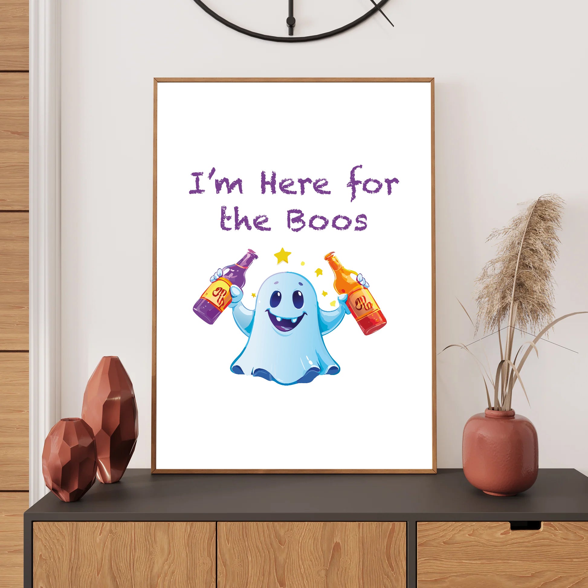 Framed poster with a ghost holding drinks and text 'I'm Here for the Boos' on a wall above a shelf.