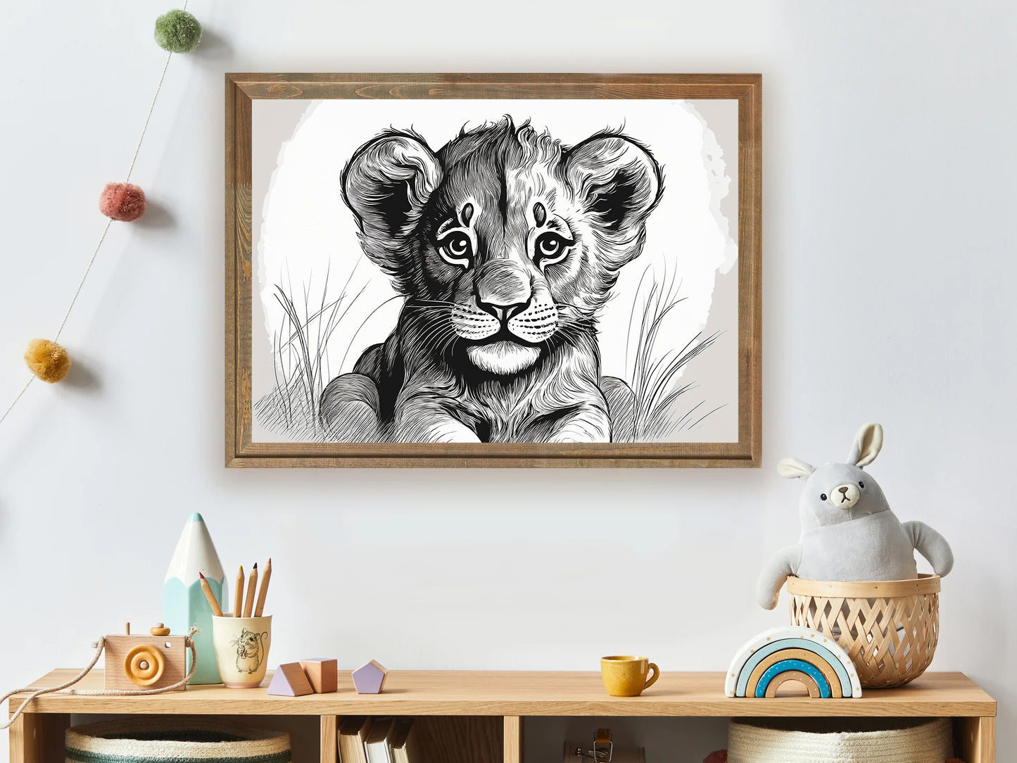 Framed artwork of a lion cub on a wall above a wooden shelf with toys.