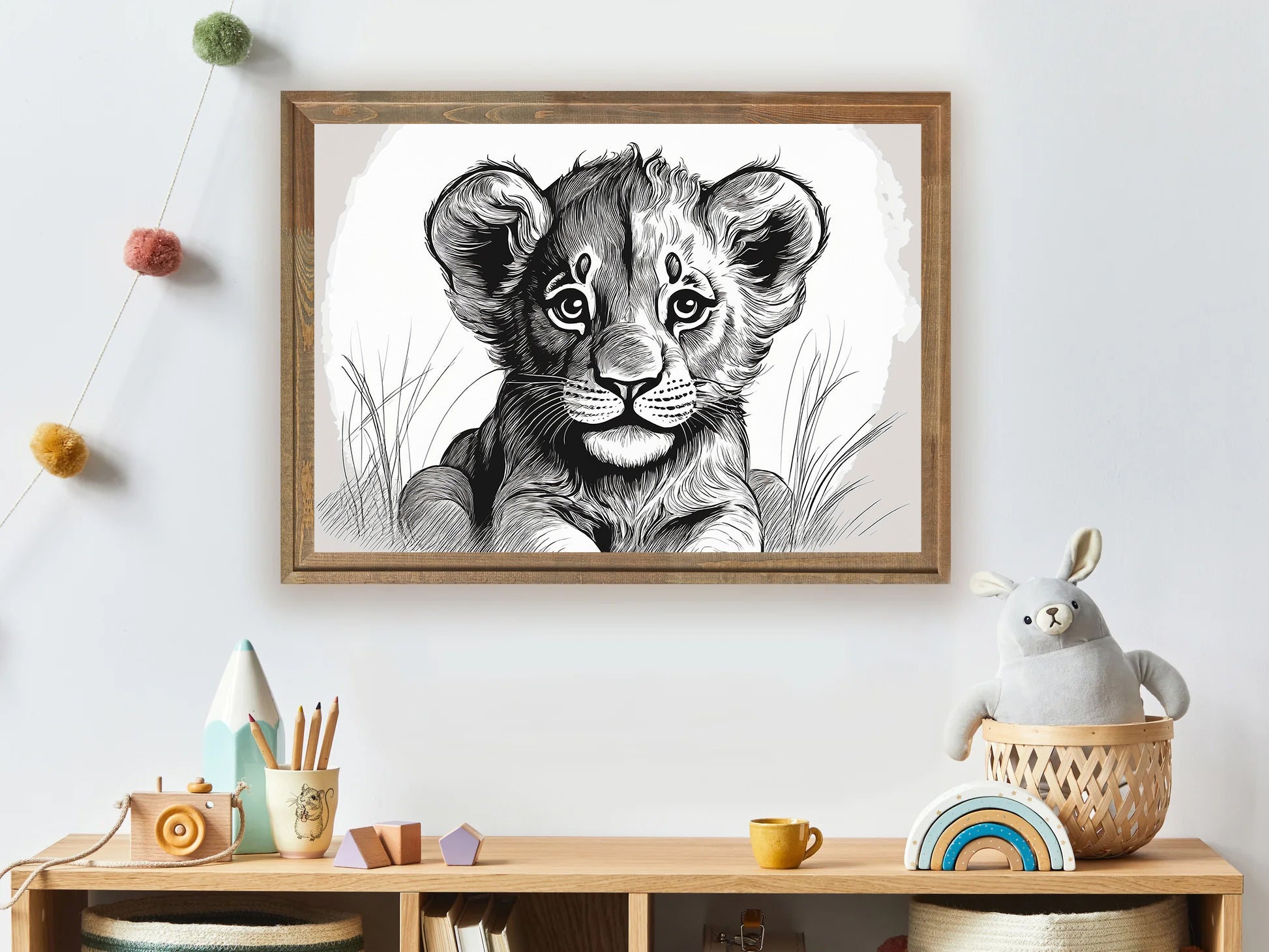 Framed artwork of a lion cub on a wall above a wooden shelf with toys.